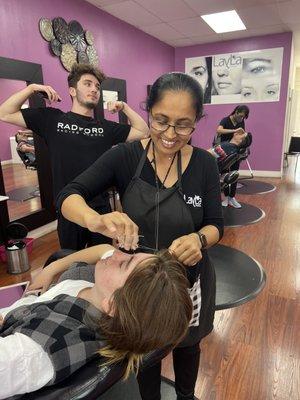 Parul, Beautician, threading a customer's brows.