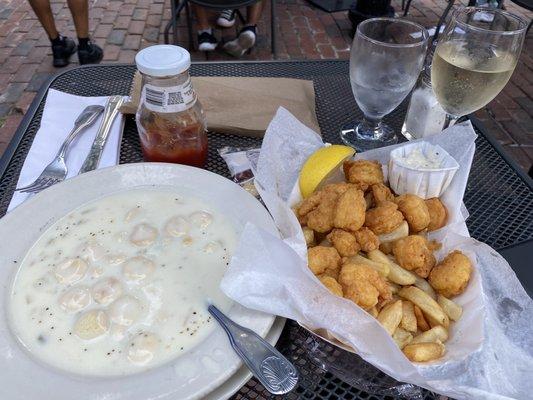 Clam chowder bowl, fried shrimp and chips basket, glass of wine