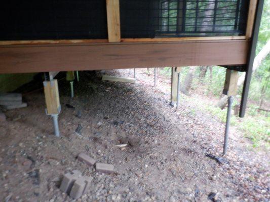 Helical piers supporting a porch.