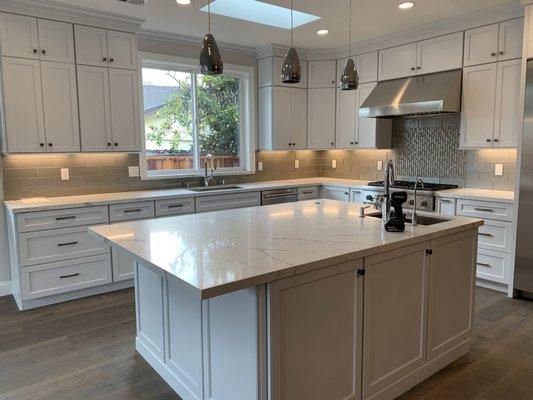 Full remodel. Tile backsplash and Calacatta Laza Quartz