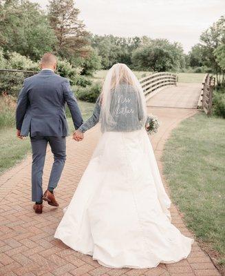 A newlywed couple running to their reception