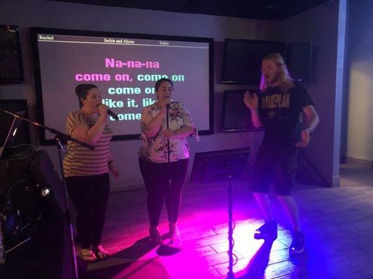 Two sisters sing a duet while another fun patron dances along!