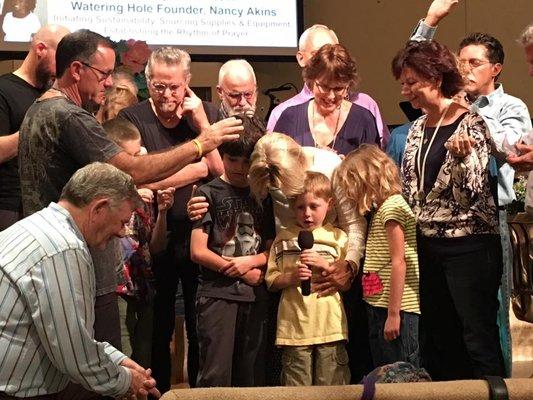 Our children praying for their teacher's missionary trip