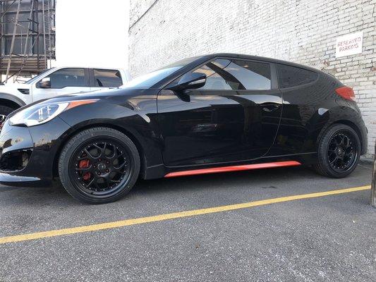 2015 Hyundai Veloster with 18" wheels. Wrapped skirts and painted calipers.