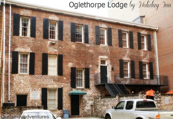 The brick courtyard enclosure on the right and steps leads to the 3 units for the Lodge.