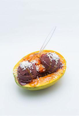 This is our delicious papaya bowl, featuring an açaí base or any base of your choice, topped with a variety of fresh fruits and toppings.