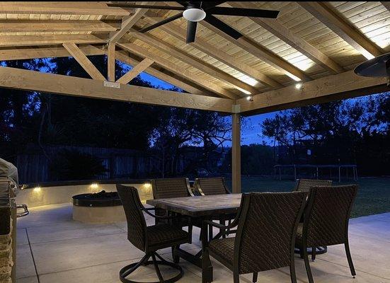 Patio cover with lighting, BBQ island, fire pit, seating area, concrete patio.