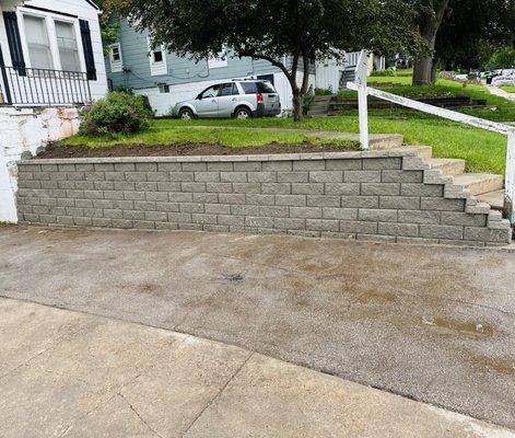 Driveway wall with improper drainage replaced with new block and proper drainage system