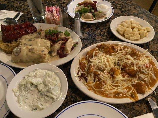 Two stuffed cabbage rolls, Bratwurst, Meat Pierogi, Saur Kraut Mushroom Pierogi, Potato pancake with pork stew