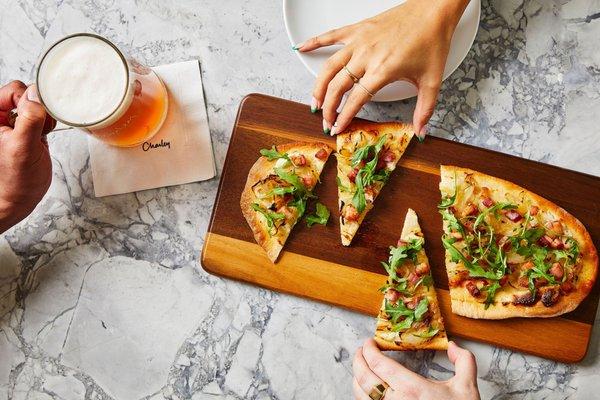 Our "Farm" Flammkuchen  flatbread with bacon, onions and arugula.