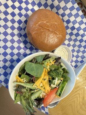 Mushroom & Swiss burger and side salad with Caesar dressing.