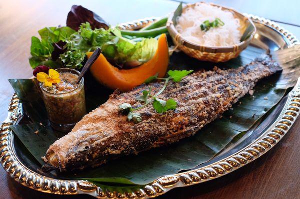 Grilled bronzino with sea salt served with assorted vegetables , vermicelli and special crunchy spicy peanut Lime sauce