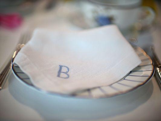 place setting with embroidered linen napkin