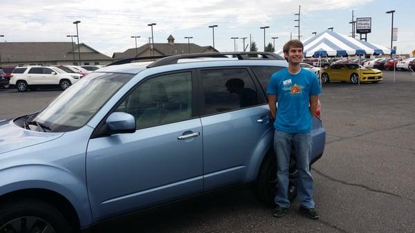 A happy boy with his first car.