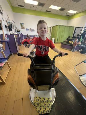 Had to try out the motorcycle too! Post-hair cut