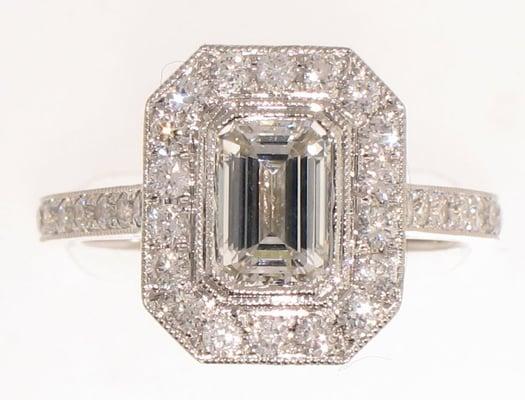 WS0629-Classic Emerald cut diamond with round brilliant diamonds pave set around the center and down the sides