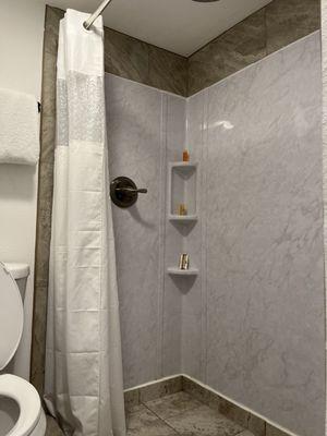 Walk-in shower with the water coming down from above. That was different. Nice tiles.