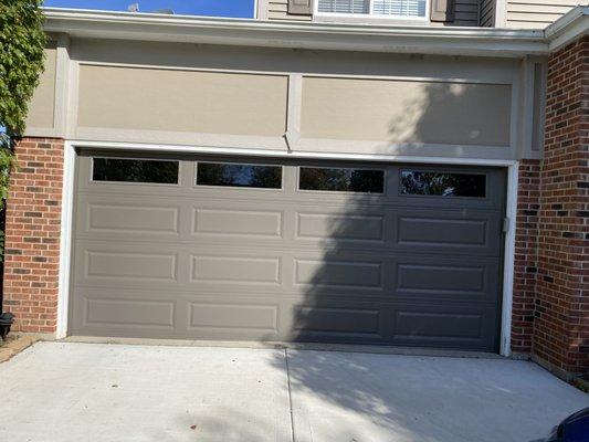 we replaced an garage door with this new glass panel door. Also wood trim and paint work.