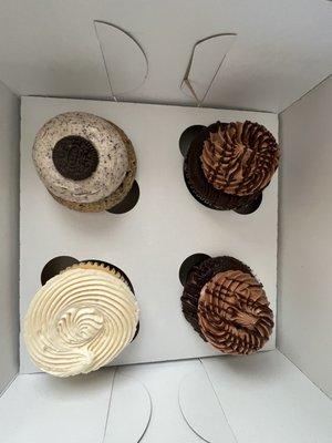 Cookies and cream, two chocolate and one vanilla bean cupcake