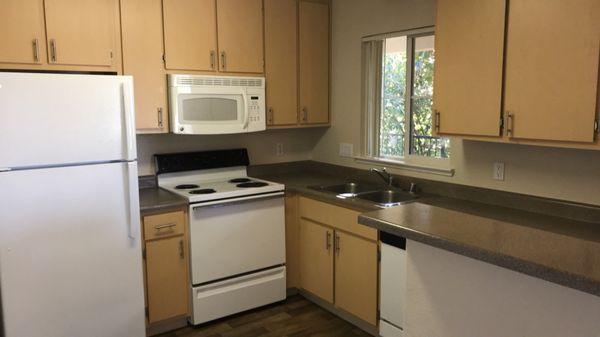 Kitchen with laminate wood flooring.