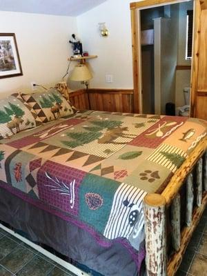 Queen size bed in Deluxe Cabin #1.  As you can see the Deluxe Cabins have been reworked and have a Log bed in them.  Nice