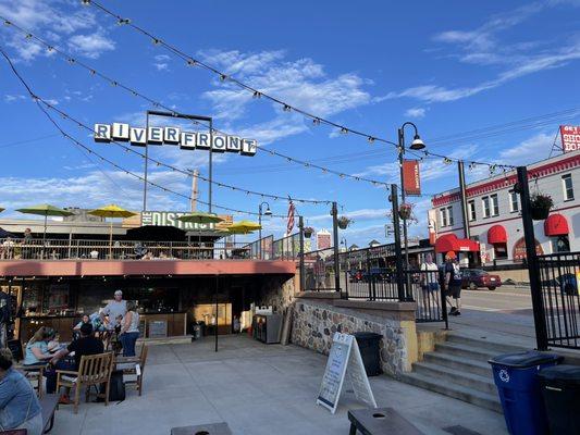 View of patio and Riverfront sign above The District