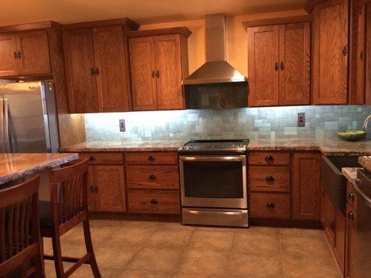 Crown molding, staggered elevations/depths on cabinets, farm sink and granite all work to make this kitchen perfect.