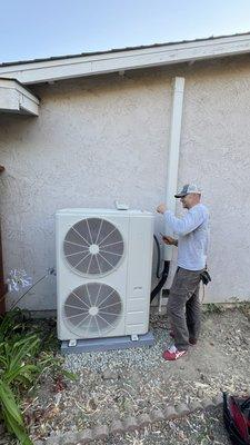 One of our lead technicians installing outdoor Carrier Heat Pump Condenser