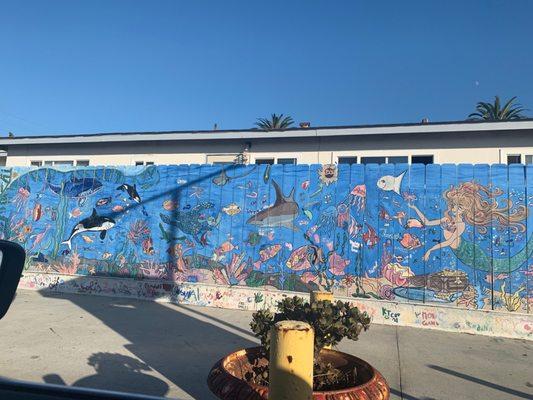 Mural on fence in lot