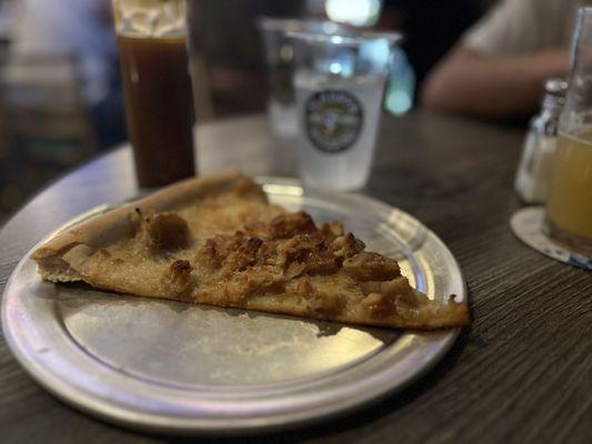 Chicken and Waffles slice with a container of glaze to super indulge the sweet tooth.