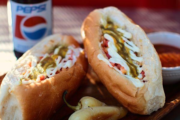 Our Sonoran hot dogs include beans, grilled & fresh onion, tomato, mayo, mustard & jalapeno sauce.