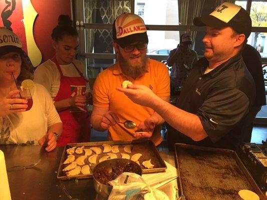 Making fruit filled empanadas in Taco team building class.