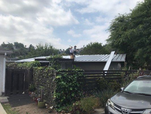 Taylor standing seam metal roof going on. Panels have locking seams.