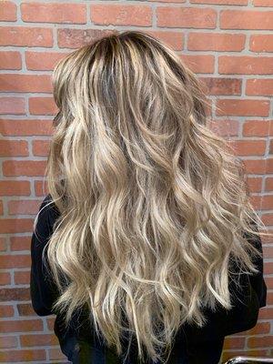 Creamy blonde highlights with a root shadow