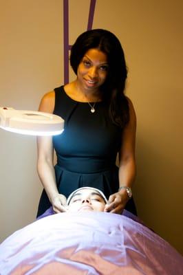 Our Esthetician, Mia cleansing the skin