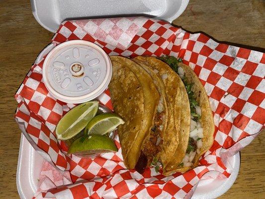 Quesabirria tacos, consome and side of limes.