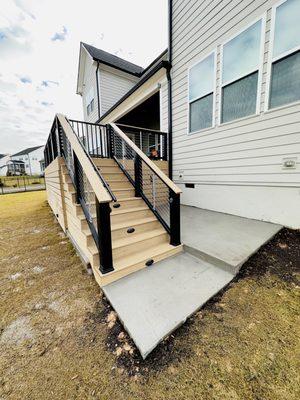 Composite deck stairs with cable railing and lighting as well as a gate