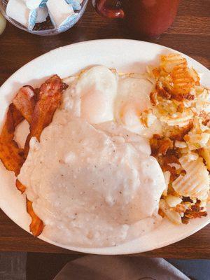 Biscuits and gravy w/ basted eggs, bacon& potatoes