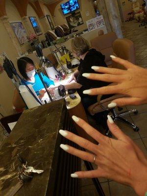 This is her nails an this is the lady , a man actually did her nails.  She needs to pay 10 to get these awful things off.