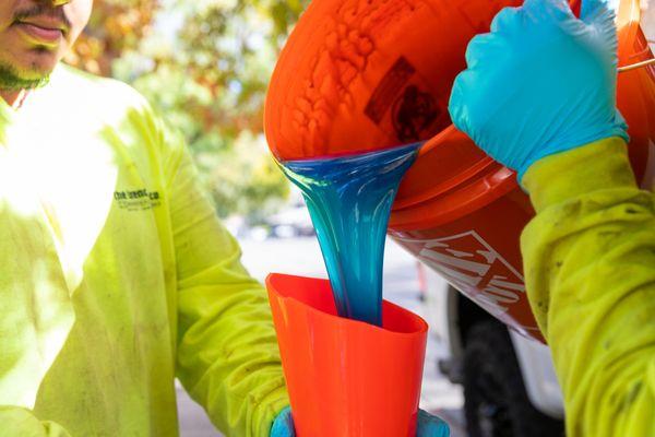 Epoxy being added to a pipe liner