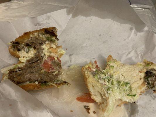 Philly steak and cheese. These are two halves, one with a little meat and one with no meat.