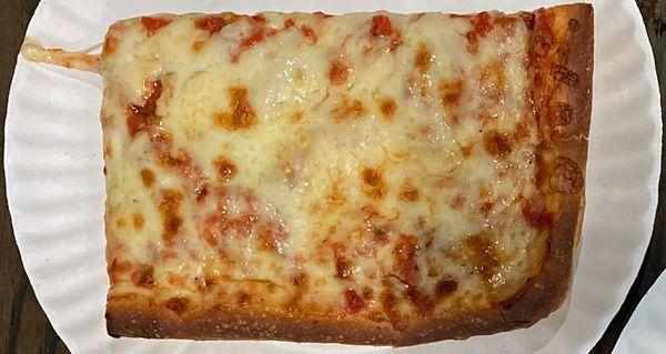 Large grandma cheese slice made with a garlicky tomato sauce