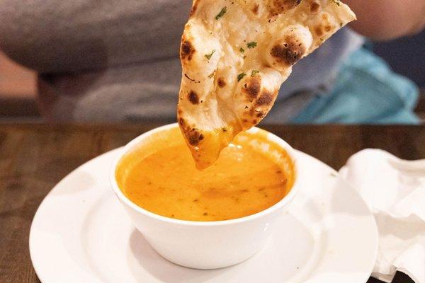 Garlic Naan dipped in tomato soup