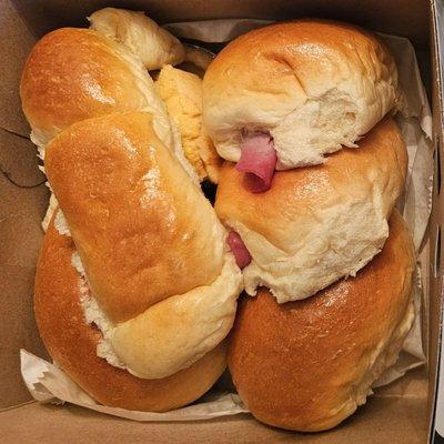 Box of goodies.  Item on left was on special (buy 4, get 1 free) - delicious coconut filling.  Ham & Cheese buns.