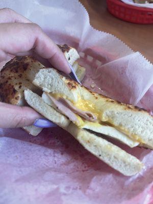 Egg, ham, and cheese on a toasted Asiago bagel. Barely any meat.