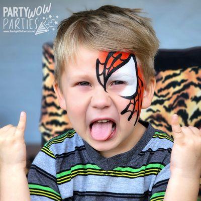 This boy is loving his Spiderman face paint!