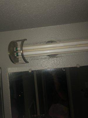 A whole in the wall behind the light allowing roaches to enter