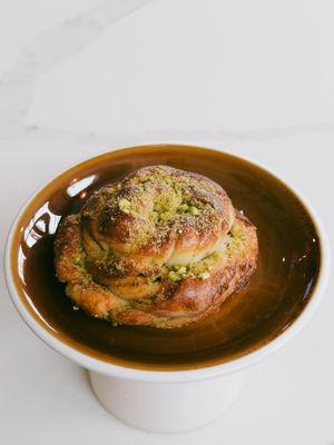 Pistachio Bun topped with crushed pistachios and a touch of sweetness.