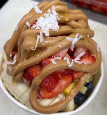 Peanut Butter Bowl:
Acai base,granola,banana,strawberries,peanut butter, honey, coconut shaving