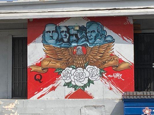 Q anon conspiracy pro insurrection mural painted in rear of building.